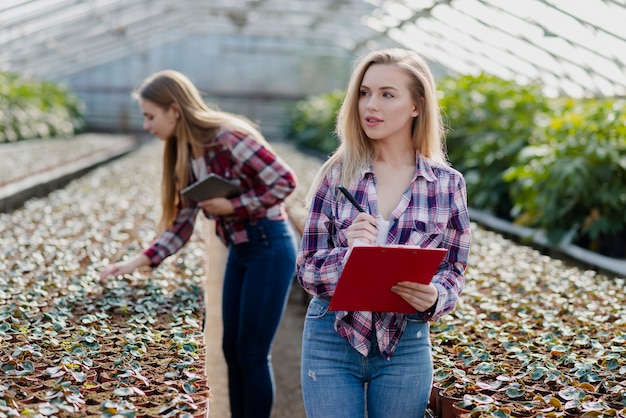 Mujeres revisando el progreso del invernadero