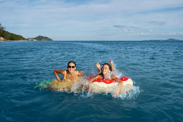 Mujeres sonrientes en ángulo alto de flotadores