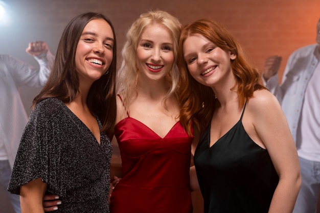 Mujeres sonrientes posando en el club de cerca