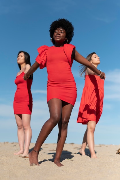 Mujeres de tiro completo tomados de la mano al aire libre