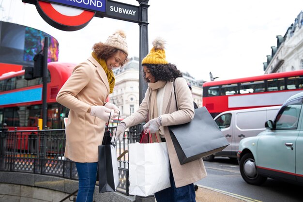 Mujeres de tiro medio con bolsas de la compra.