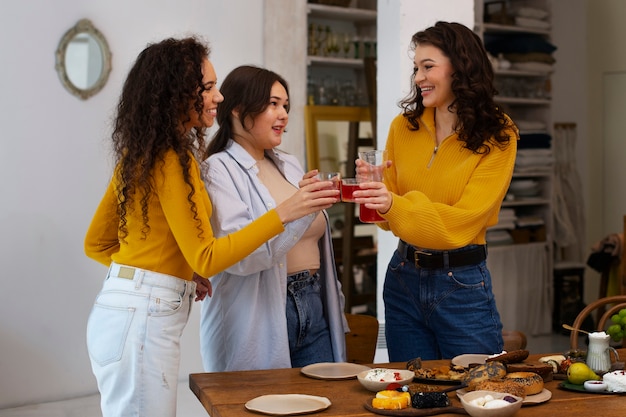 Mujeres de tiro medio con comida deliciosa