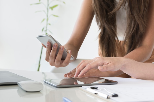 Mujeres trabajando juntas en diferentes dispositivos