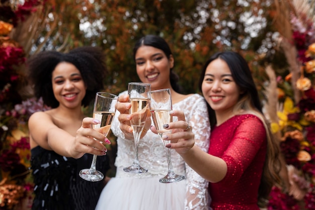 Foto gratuita mujeres de vista frontal posando con bebidas