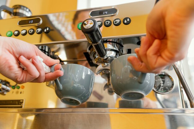 Ángulo bajo de mujer barista con máquina de café