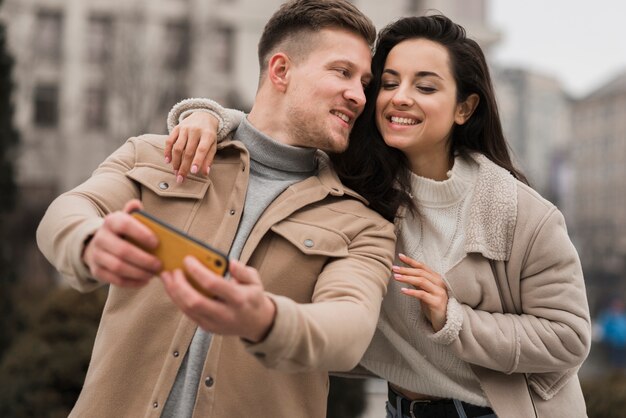 Ángulo bajo de pareja tomando una selfie