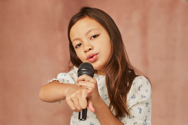 Niña aprendiendo a cantar en casa