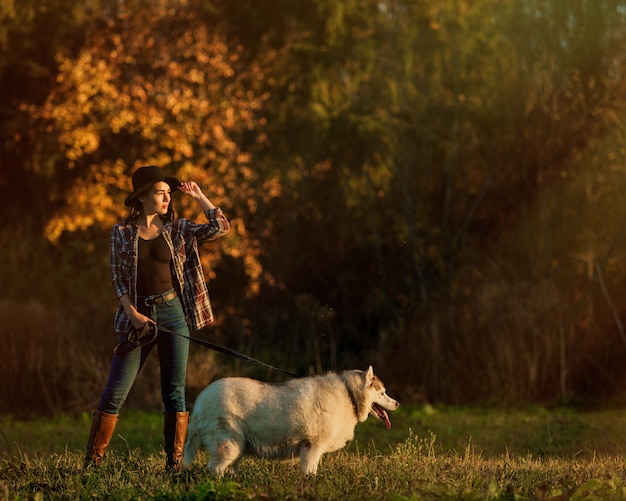 Niña camina con husky