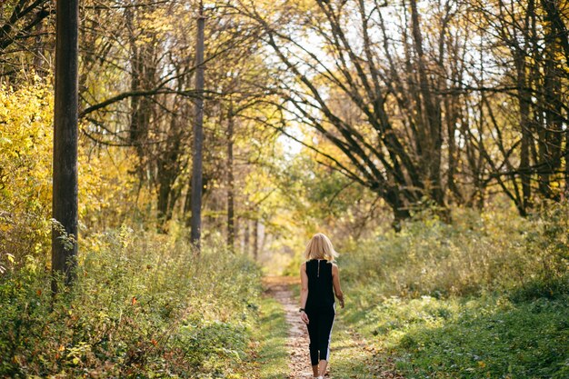 niña caminando en el parque de otoño