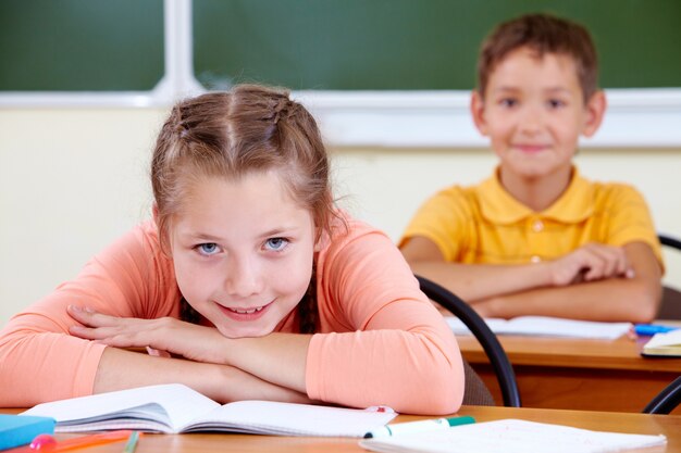 Niña con el colegial en el fondo