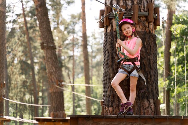 Niña divirtiéndose en un parque de aventuras