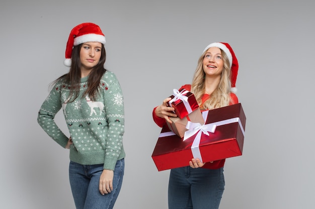 Niña feliz con regalos y niña infeliz sin nada.