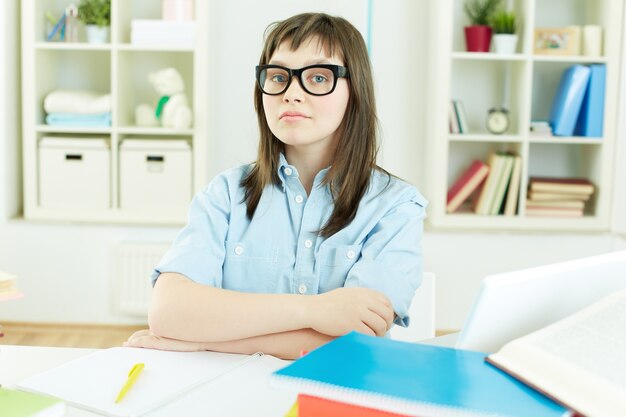 Niña con gafas haciendo deberes