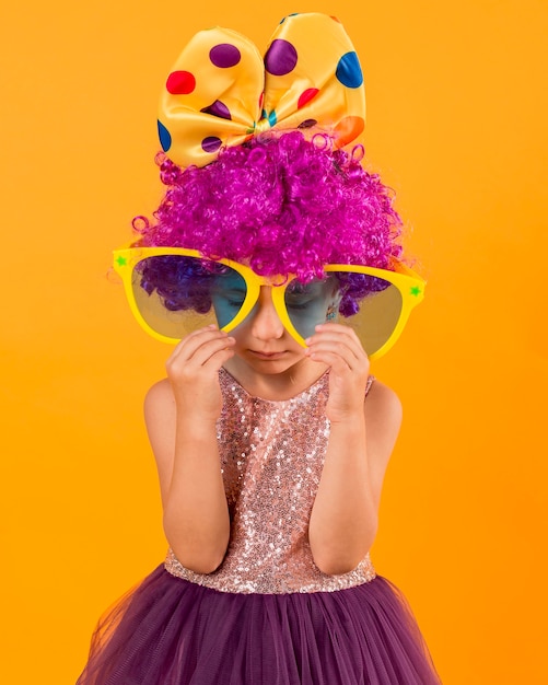 Foto gratuita niña con grandes gafas de sol y peluca de payaso