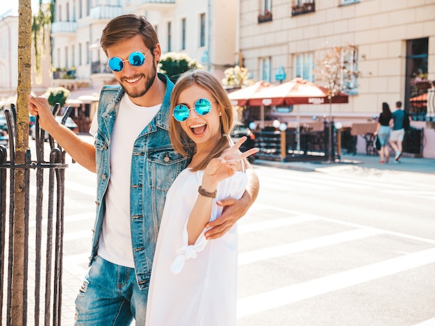 Niña hermosa sonriente y su novio guapo posando en la calle.