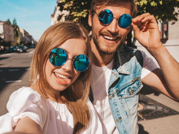 Niña hermosa sonriente y su novio guapo en ropa casual de verano.