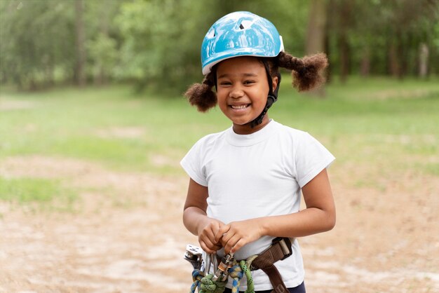 Niña linda divirtiéndose en un parque de aventuras