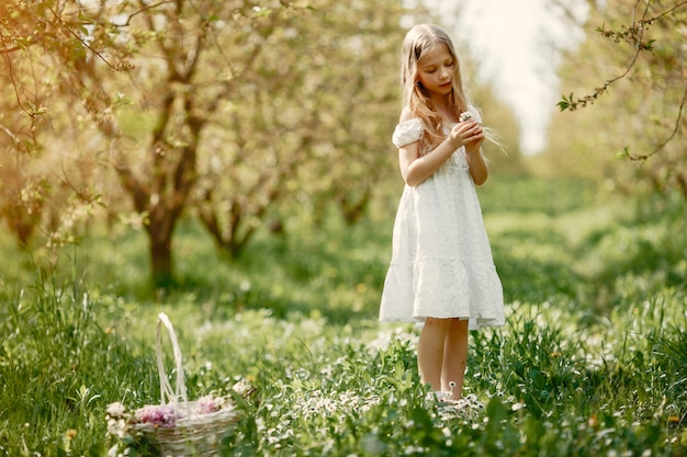 Niña linda en un parque de primavera