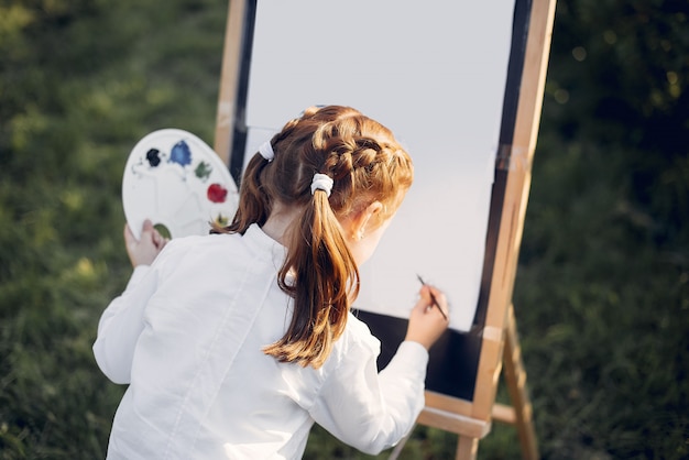 Niña linda pintando en un parque