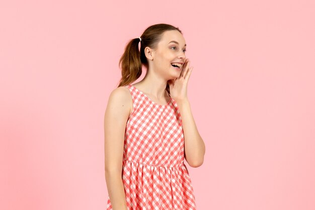 niña en lindo vestido rosa con cara sonriente en rosa