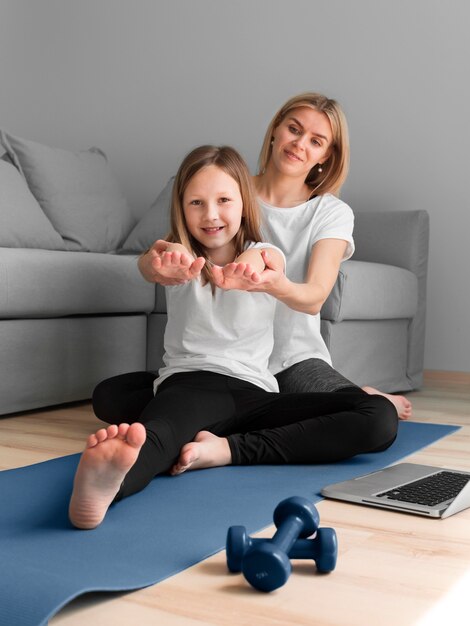 Niña con mamá entrenamiento deportivo con pesas