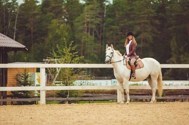 la niña monta un caballo