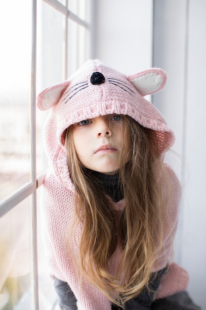 Niña rubia con suéter rosa