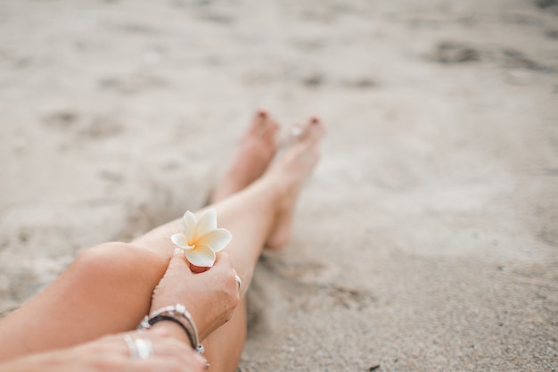 la niña esta sentada en la playa