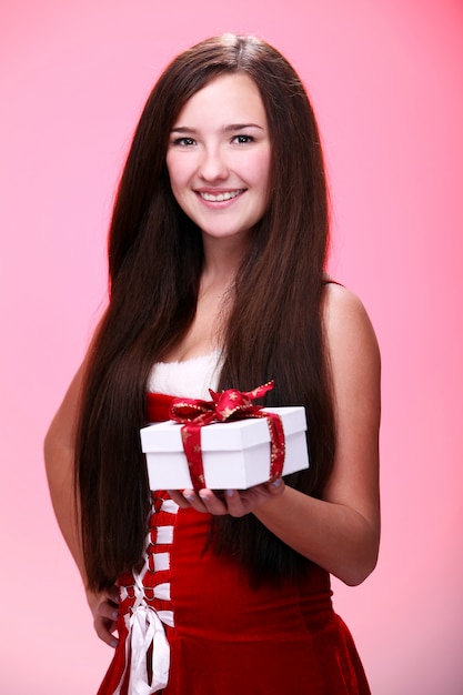 Niña sonriendo con un regalo de Navidad