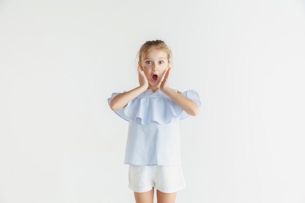 Niña sonriente con estilo posando en ropa casual aislado en el espacio en blanco. Modelo de mujer rubia caucásica. Emociones humanas, expresión facial, infancia, rebajas