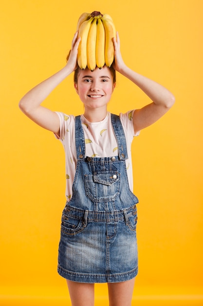 Niña sonriente con plátanos