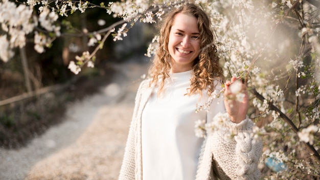 Niña sonriente y ramas con flores