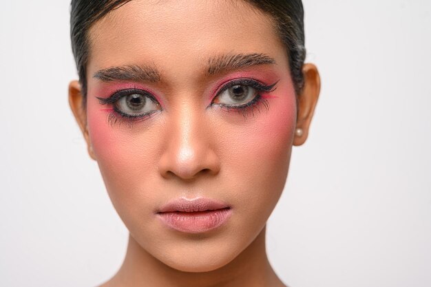 La niña tenía un hermoso maquillaje rosa aislado en blanco