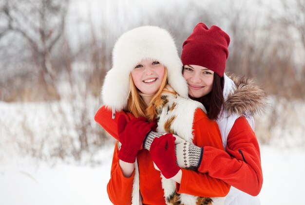 Las niñas juegan en el parque de invierno