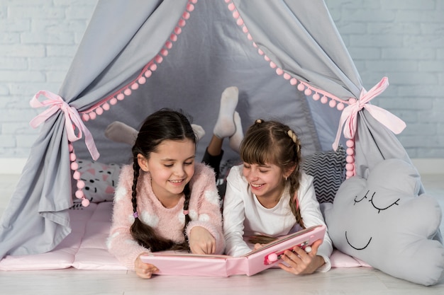 Foto gratuita niñas leyendo juntas