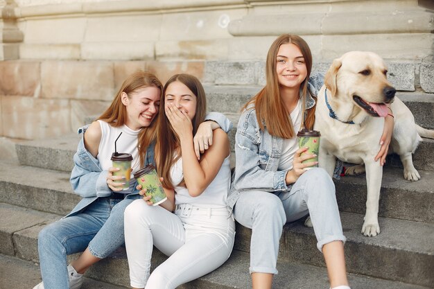 Niñas sentadas en una escalera con lindo perro