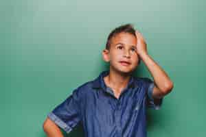 Foto gratuita niño cansado con las manos en la cara