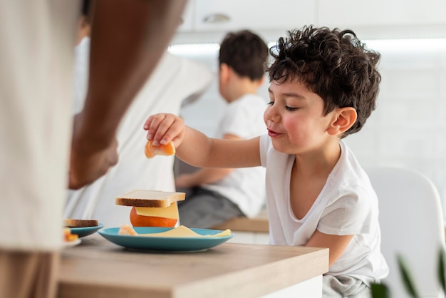 Foto gratuita niño desayunando con su papá