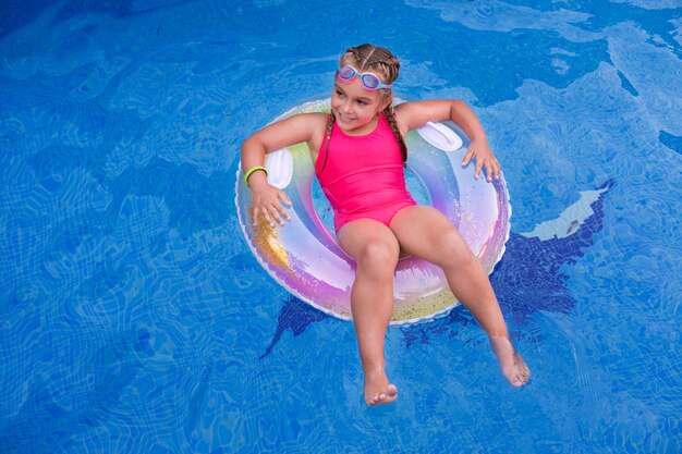 Niño divirtiéndose con flotador en la piscina