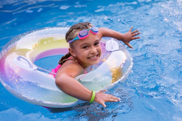 Niño divirtiéndose con flotador en la piscina