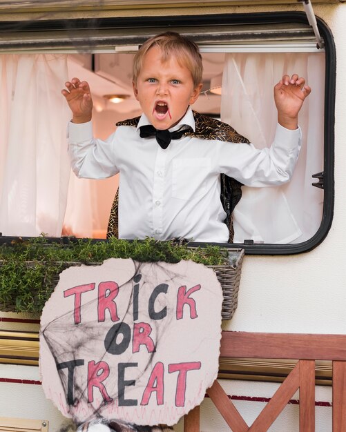 Niño espeluznante con cartel de halloween