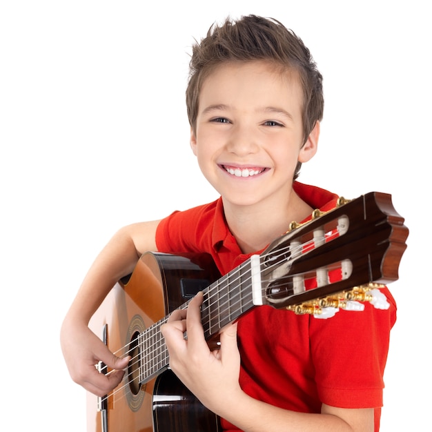 Foto gratuita niño feliz está tocando la guitarra acústica, aislada