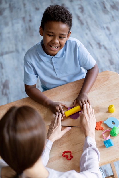 Niño haciendo una sesión de terapia ocupacional con un psicólogo