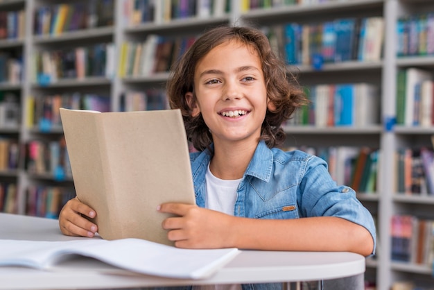 Niño haciendo sus deberes en la biblioteca.