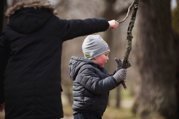 Niño jugando con un palo en el parque