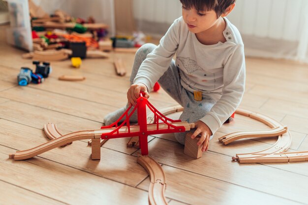 Niño jugando con tren de juguete