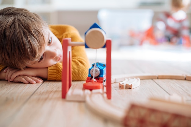 Niño jugando con tren de juguete