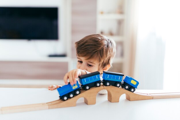 Niño jugando con tren de juguete