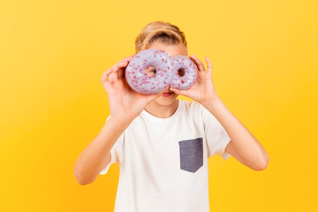 Niño juguetón con donas