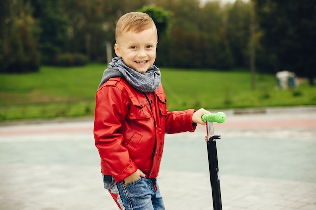 Niño lindo en un parque jugando en un césped